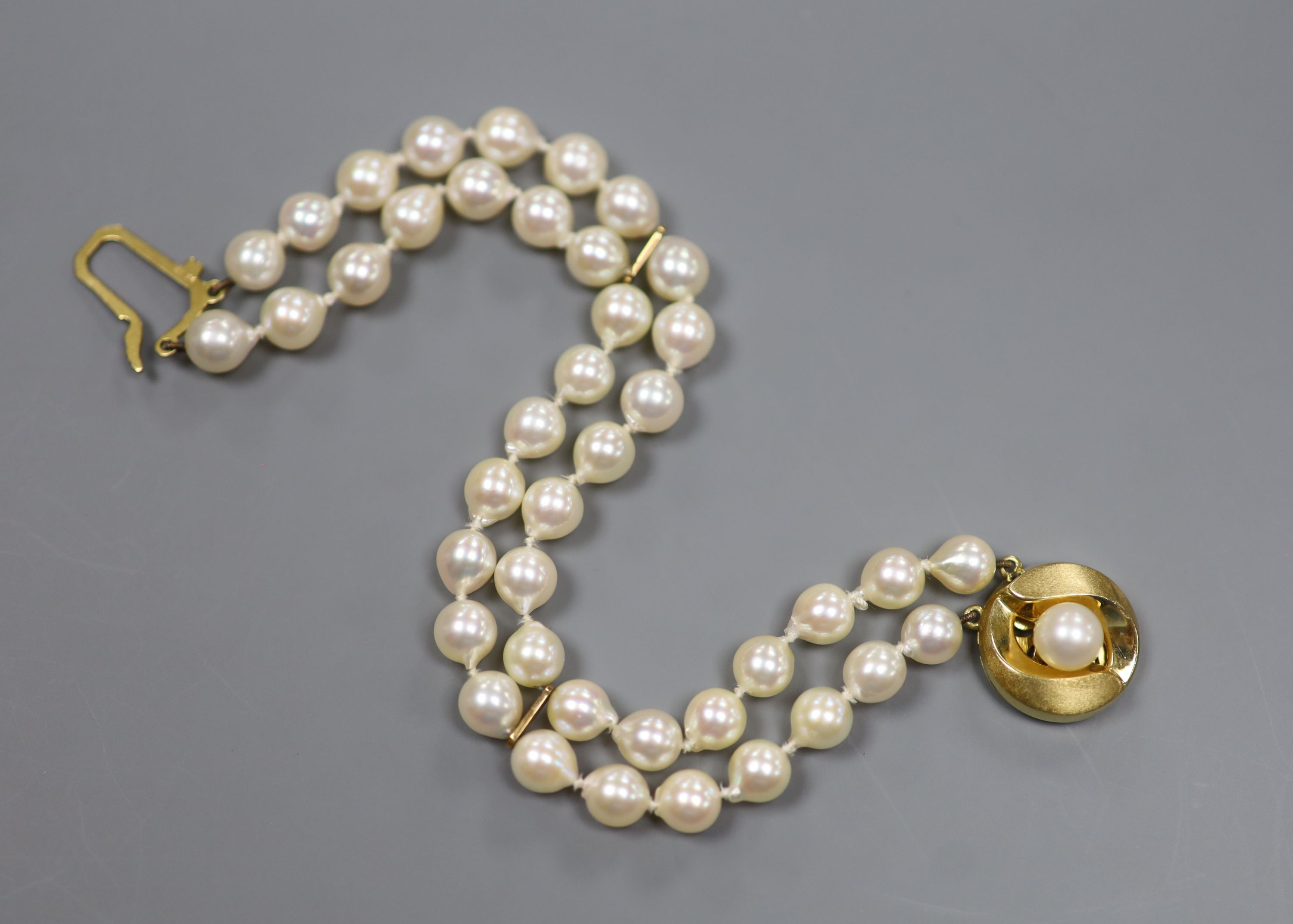 A modern double strand cultured pearl bracelet with a 9ct and cultured pearl clasp, 18cm